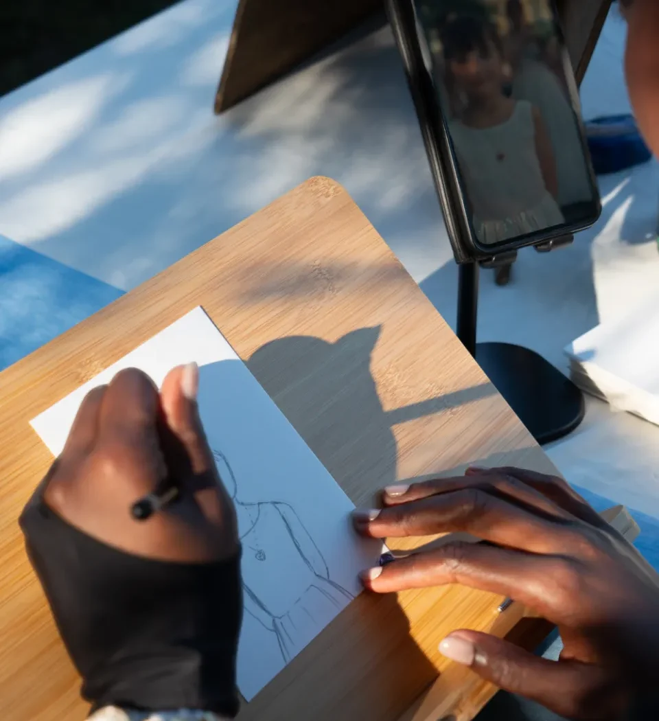 Femme entrain de dessiner un portrait au crayon